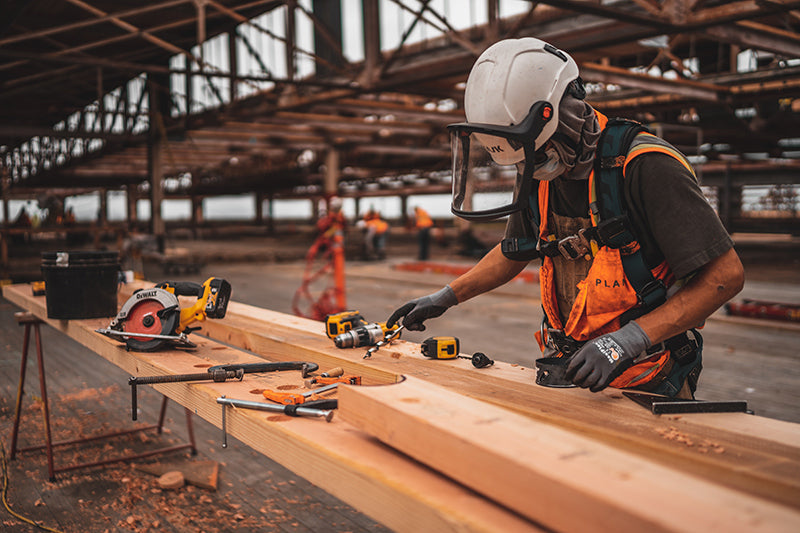 A man working with tools on a construction site.  