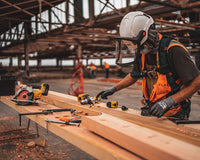 A man working with tools on a construction site.  