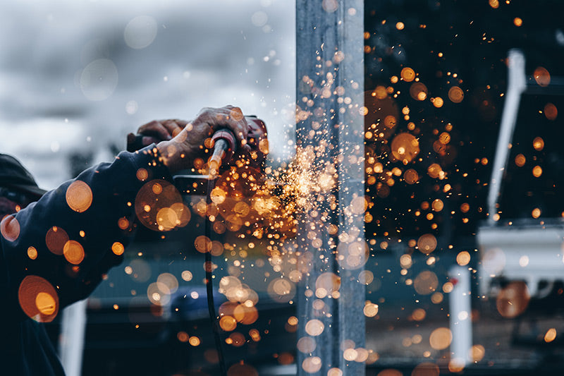 A construction worker causing sparks