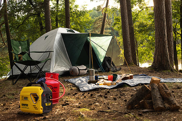 Camping setup with tent, campfire, and supplies in a forest