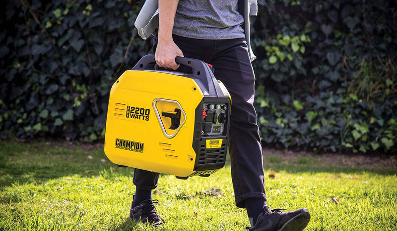 Man carrying Champion Inverter Generator