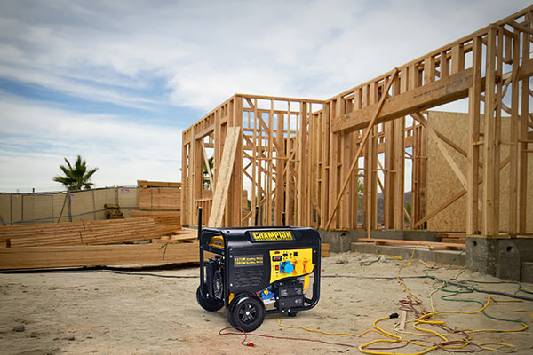 Champion power generator in front of a wooden house construction site