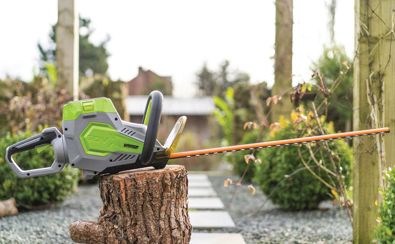 Warrior Eco 61cm Cordless Hedge Trimmer sitting on a tree stump